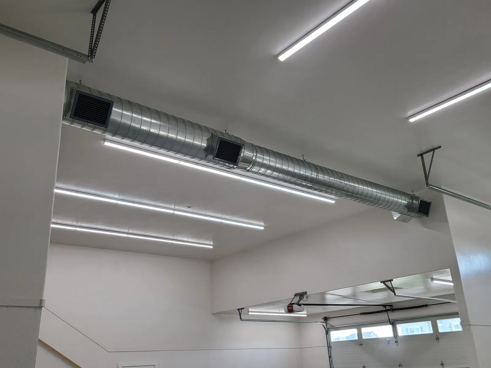 Sheet metal ductwork installed in a shop ceiling