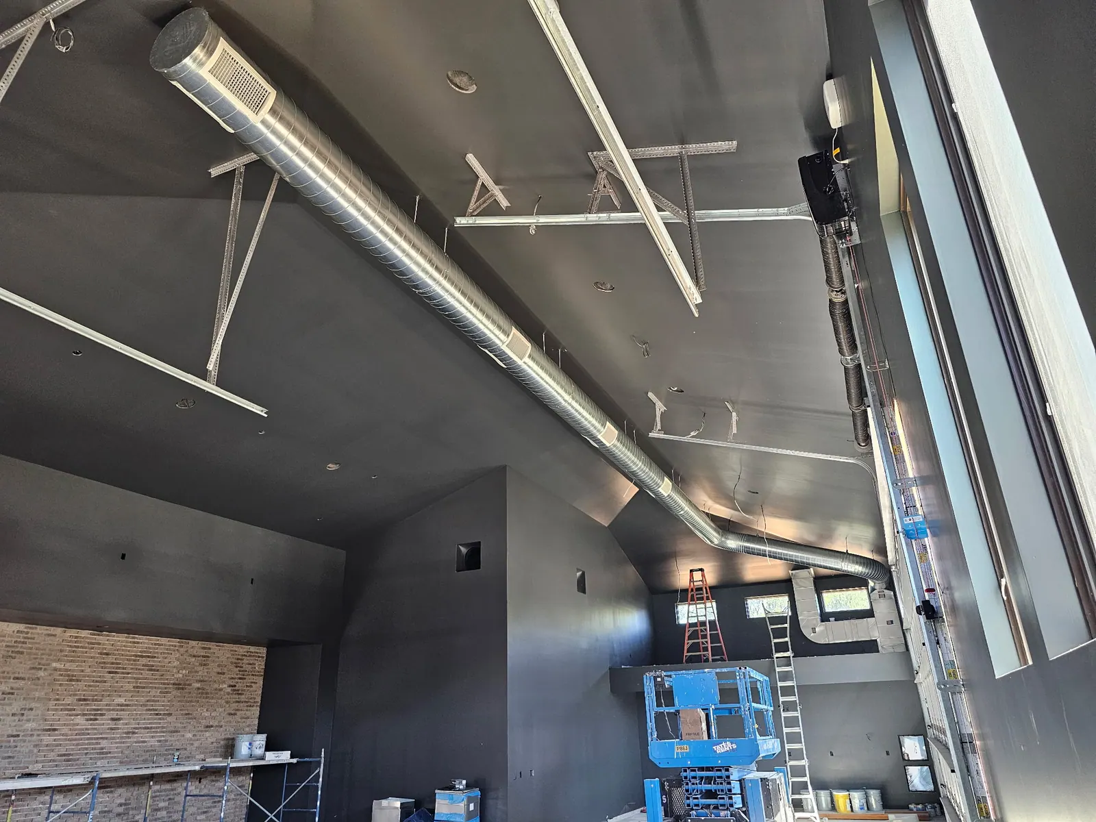 Custom sheet metal ductwork in a large shop space